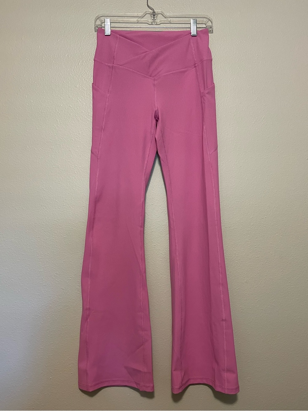 Fabletics Pink Flared Leggings with Side Pockets criss cross waist